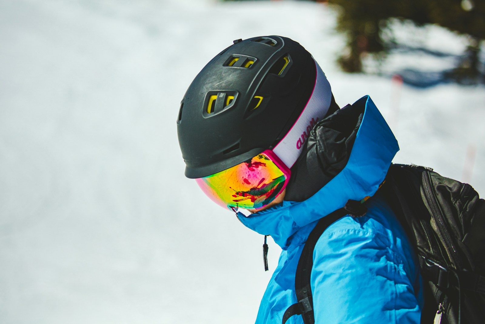 person in blue jacket wearing black helmet